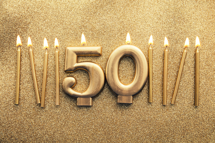 Number 50 Gold Celebration Candles on a Glitter Background